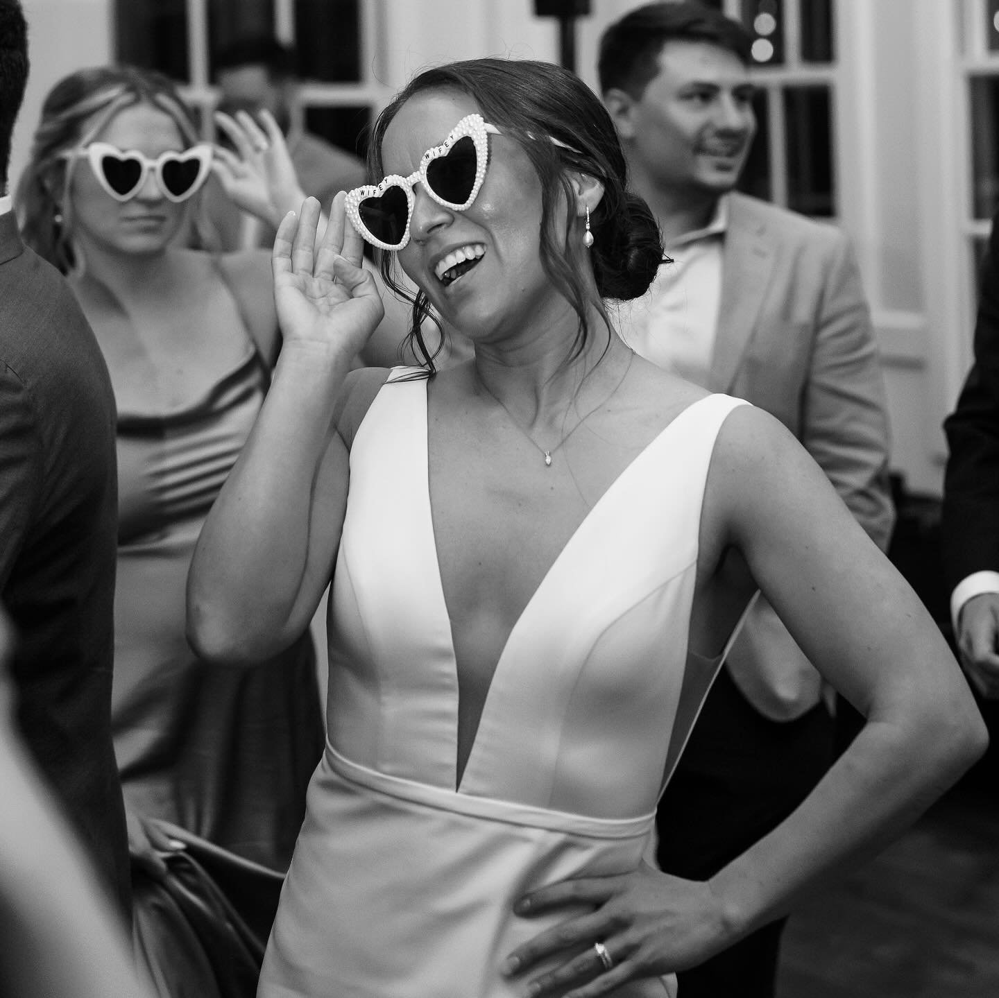 Bride dancing in heart sunglasses